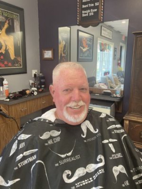 Client all smiles after a fresh haircut